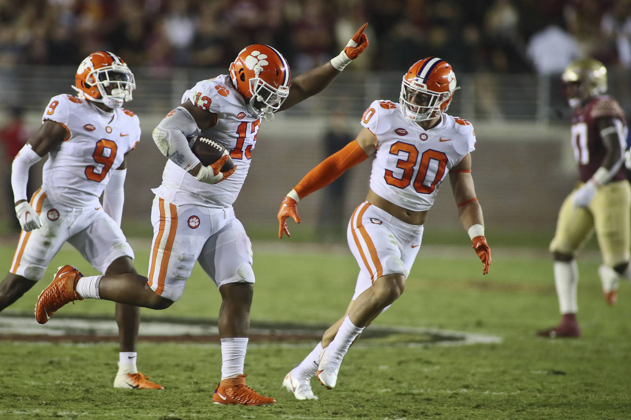 Clemson defensive tackle Tyler Davis (13) celebrates his fumble recovery with safety R.J. Mickens (...