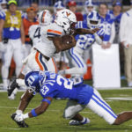 
              Virginia's Perris Jones avoids a tackle by Duke's Terry Moore (23) during the first half of an NCAA college football game in Durham, N.C., Saturday, Oct. 1, 2022. (AP Photo/Ben McKeown)
            