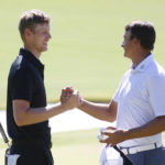 
              Cam Davis, left, of Australia, shakes hands with Christiaan Bezuidenhout, of South Africa, after finishing round two of the Shriners Children's Open golf tournament on the ninth hole at TPC Summerlin, Friday, Oct. 7, 2022, in Las Vegas. (AP Photo/Ronda Churchill)
            