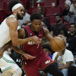 
              Miami Heat guard Kyle Lowry (7) goes around Boston Celtics guard Derrick White (9) during the first half of an NBA game Friday, Oct. 21, 2022, in Miami. (AP Photo/Marta Lavandier)
            