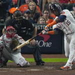 
              Houston Astros' Martin Maldonado hits hits an RBI single during the second inning in Game 1 of baseball's World Series between the Houston Astros and the Philadelphia Phillies on Friday, Oct. 28, 2022, in Houston. (AP Photo/Sue Ogrocki)
            