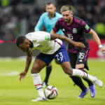
              FILE - United States' Kellyn Acosta (23) and Mexico's Hector Herrera compete for the ball during a qualifying soccer match for the FIFA World Cup Qatar 2022 at Azteca stadium in Mexico City, Thursday, March 24, 2022. (AP Photo/Eduardo Verdugo, File)
            