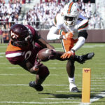 
              Virginia Tech's Malachi Thomas (24) dives in for a touchdown past Miami's James Williams (0) in the second half of an NCAA football game, Saturday Oct. 15 2022,  in Blacksburg Va. (Matt Gentry/The Roanoke Times via AP)
            