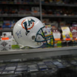 
              A football helmet signed by former Miami Dolphins coach Don Shula with the 1997 date of his induction into the Pro Football Hall of Fame is displayed on a counter inside a sports memorabilia store, Bases Loaded Sports Cards, in Miami, Wednesday, Oct. 12, 2022. (AP Photo/Rebecca Blackwell)
            
