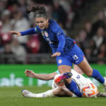 
              United States' Sophia Smith challenges for the ball with England's Millie Bright, bottom, during the women's friendly soccer match between England and the US at Wembley stadium in London, Friday, Oct. 7, 2022. (AP Photo/Kirsty Wigglesworth)
            