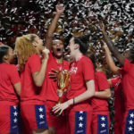 
              Gold medalists the United States hold their trophy as they celebrate on the podium after defeating China in the final at the women's Basketball World Cup in Sydney, Australia, Saturday, Oct. 1, 2022. (AP Photo/Mark Baker)
            