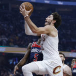 
              Cleveland Cavaliers forward Cedi Osman (16) goes up for a shot against Washington Wizards forward Will Barton (5) during the first half of a NBA basketball game, Sunday, Oct. 23, 2022, in Cleveland. (AP Photo/Ron Schwane)
            