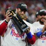 
              Philadelphia Phillies designated hitter Bryce Harper celebrates with the trophy after winning the baseball NL Championship Series in Game 5 against the San Diego Padres on Sunday, Oct. 23, 2022, in Philadelphia. (AP Photo/Matt Slocum)
            