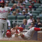 
              Philadelphia Phillies first baseman Rhys Hoskins (17) scores on a Philadelphia Phillies right fielder Nick Castellanos single during the fourth inning in Game 1 of a National League Division Series baseball game, Tuesday, Oct. 11, 2022, in Atlanta. (AP Photo/Brynn Anderson)
            