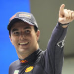 
              Red Bull driver Sergio Perez of Mexico celebrates after winning the Singapore Formula One Grand Prix, at the Marina Bay City Circuit in Singapore, Sunday, Oct.2, 2022. (AP Photo/Vincent Thian)
            