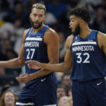 
              Minnesota Timberwolves center Rudy Gobert (27), left, and center Karl-Anthony Towns (32) talk during the first half of an NBA basketball game against the San Antonio Spurs, Wednesday, Oct. 26, 2022, in Minneapolis. (AP Photo/Abbie Parr)
            