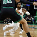 
              Cleveland Cavaliers' Donovan Mitchell drives between two Boston Celtics defenders during the second quarter of an NBA basketball game Friday, Oct. 28, 2022, in Boston. (AP Photo/Winslow Townson)
            