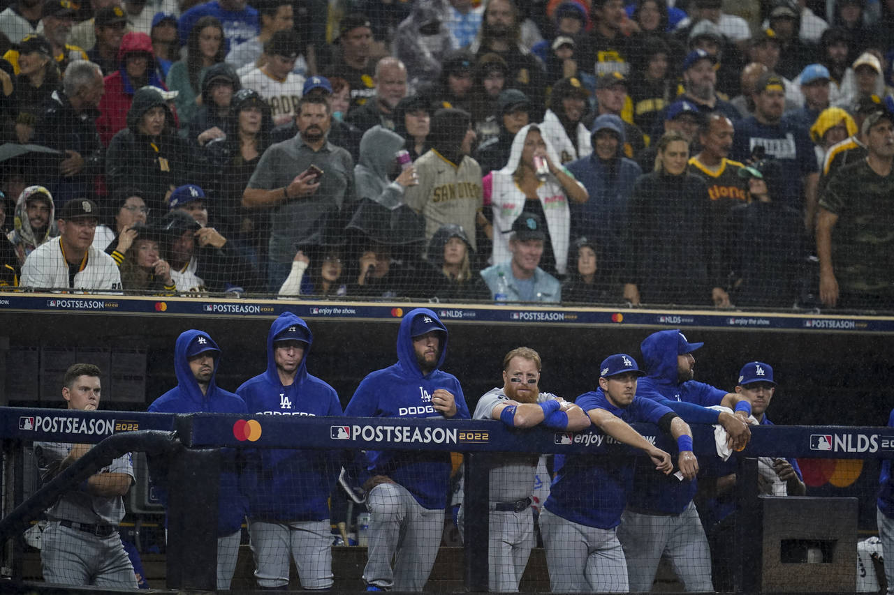 Members of the Los Angeles Dodgers look on from the dugout during the ninth inning in Game 4 of a b...