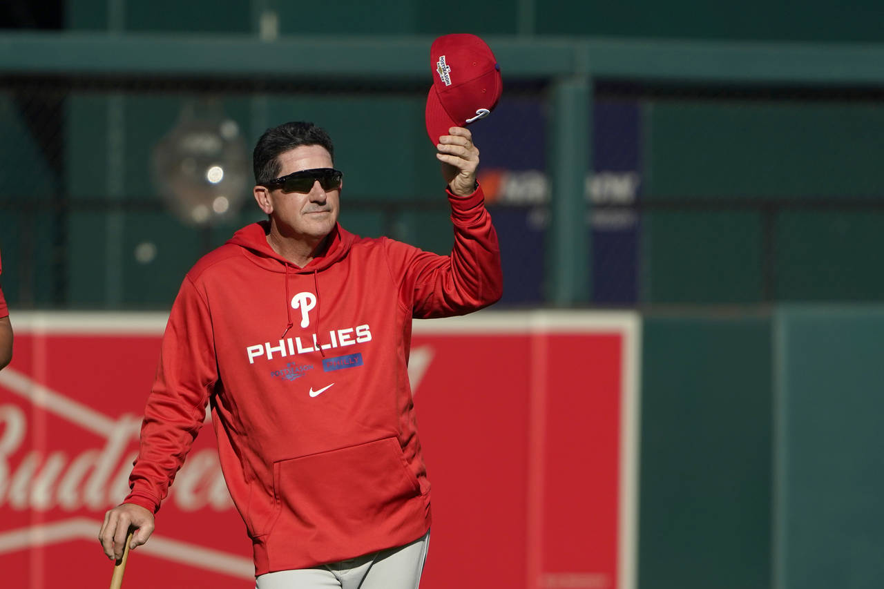 Philadelphia Phillies interim manager Rob Thomson removes his cap during baseball practice Thursday...