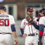 
              Atlanta Braves catcher Travis d'Arnaud right, and shortstop Dansby Swanson center, visit the mound to talk with starting pitcher Charlie Morton left, in the third inning of a baseball against the New York Mets, Sunday, Oct. 2, 2022, in Atlanta. (AP Photo/Hakim Wright Sr.)
            