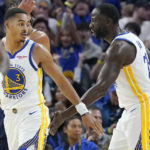 
              Golden State Warriors guard Jordan Poole (3) is congratulated by forward Draymond Green after scoring against the Denver Nuggets during the first half of an NBA preseason basketball game in San Francisco, Friday, Oct. 14, 2022. (AP Photo/Jeff Chiu)
            