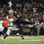 
              New Orleans Saints wide receiver Keith Kirkwood (18) catches a pass as Cincinnati Bengals cornerback Mike Hilton (21) defends during the second half of an NFL football game in New Orleans, Sunday, Oct. 16, 2022. (AP Photo/Gerald Herbert)
            