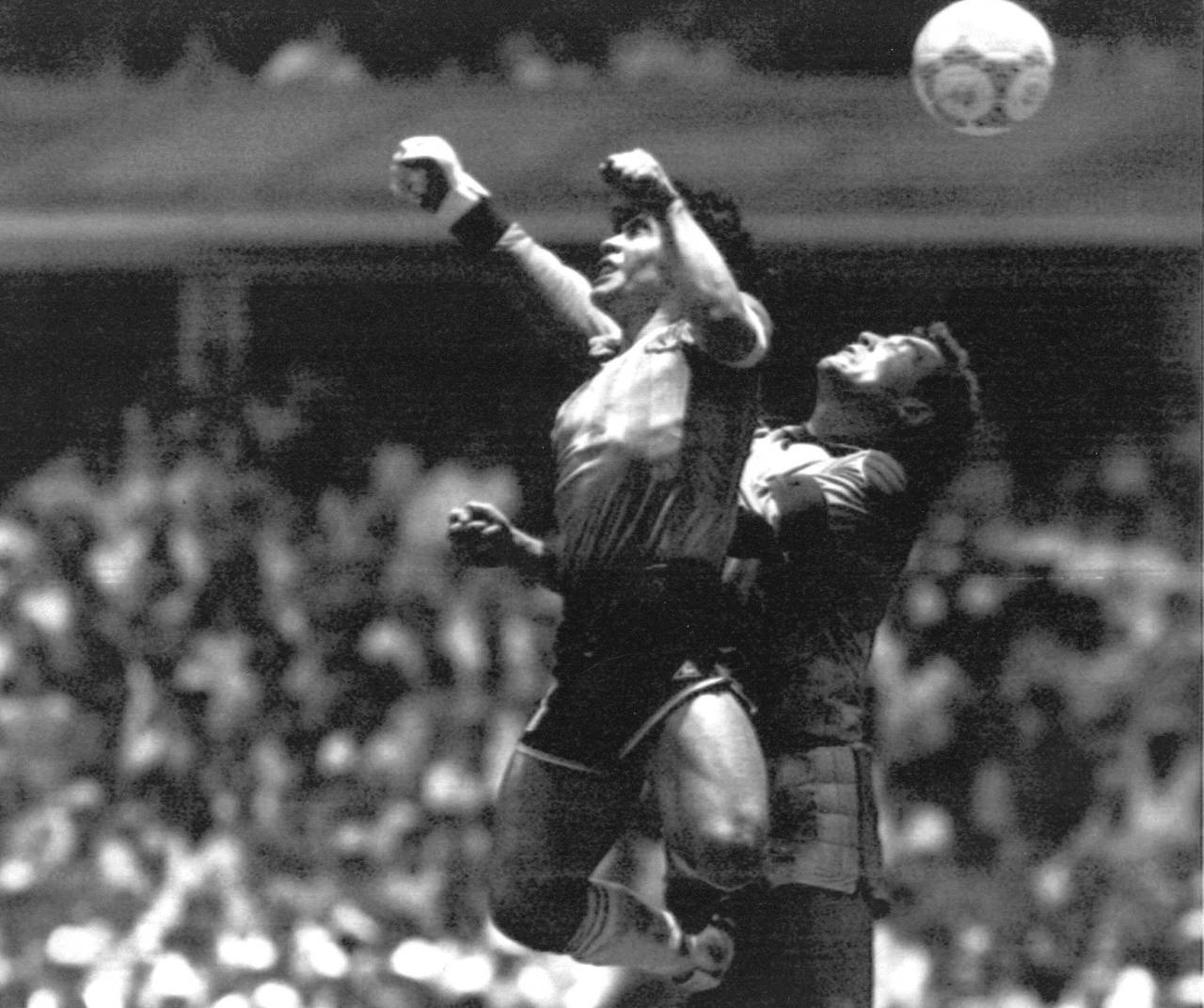 FILE - Argentina's Diego Maradona, left, beats England goalkeeper Peter Shilton to a high ball and ...