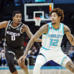 
              Charlotte Hornets guard Kelly Oubre Jr. (12) drives around Sacramento Kings guard Malik Monk (0) during the first half of an NBA basketball game Monday, Oct. 31, 2022, in Charlotte, N.C. (AP Photo/Rusty Jones)
            