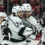 
              Los Angeles Kings center Phillip Danault (24) celebrates his game winning goal during overtime with Quinton Byfield (55) after an NHL hockey game against the Detroit Red Wings Monday, Oct. 17, 2022, in Detroit. The Kings won 5-4. (AP Photo/Paul Sancya)
            