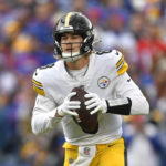 
              Pittsburgh Steelers quarterback Kenny Pickett (8) looks to pass during the first half of an NFL football game against the Buffalo Bills in Orchard Park, N.Y., Sunday, Oct. 9, 2022. (AP Photo/Adrian Kraus)
            
