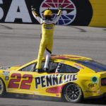 
              Joey Logano celebrates after winning a NASCAR Cup Series auto race Sunday, Oct. 16, 2022, in Las Vegas. (AP Photo/John Locher)
            