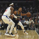 
              New Orleans Pelicans guard CJ McCollum, right, is blocked by Los Angeles Clippers guard Terance Mann during the first half of an NBA basketball game on Sunday, Oct. 30, 2022, in Los Angeles, Calif. (AP Photo/Allison Dinner)
            