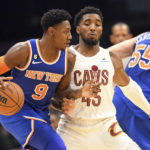 
              New York Knicks guard RJ Barrett (9) drives against Cleveland Cavaliers guard Donovan Mitchell (45) during the first half of an NBA basketball game, Sunday, Oct. 30, 2022, in Cleveland. (AP Photo/Nick Cammett)
            