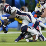 
              Los Angeles Chargers wide receiver Joshua Palmer (5) makes a catch as Denver Broncos safety Kareem Jackson makes the hit during the second half of an NFL football game, Monday, Oct. 17, 2022, in Inglewood, Calif. (AP Photo/Marcio Jose Sanchez)
            
