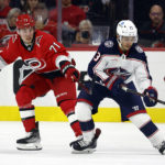 
              Columbus Blue Jackets' Johnny Gaudreau (13) controls the puck with Carolina Hurricanes' Jesper Fast (71) defending during the second period of an NHL hockey game in Raleigh, N.C., Wednesday, Oct. 12, 2022. (AP Photo/Karl B DeBlaker)
            