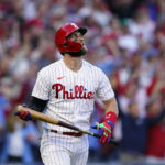 
              Philadelphia Phillies designated hitter Bryce Harper (3) watches his two-run home run during the third inning in Game 3 of baseball's National League Division Series against the Atlanta Braves, Friday, Oct. 14, 2022, in Philadelphia. (AP Photo/Matt Rourke)
            