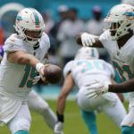 
              Miami Dolphins quarterback Skylar Thompson (19) hands off to Miami Dolphins running back Raheem Mostert (31) during the first half of an NFL football game against the Minnesota Vikings, Sunday, Oct. 16, 2022, in Miami Gardens, Fla. (AP Photo/Lynne Sladky)
            