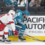 
              Carolina Hurricanes left wing Jordan Martinook (48) and San Jose Sharks defenseman Mario Ferraro (38) compete for possession of the puck during the first period of an NHL hockey game in San Jose, Calif., Friday, Oct. 14, 2022. (AP Photo/Godofredo A. Vásquez)
            