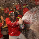 
              Philadelphia Phillies' Brandon Marsh celebrates after the Phillies won a baseball game against the Houston Astros to clinch a wild-card playoff spot, Monday, Oct. 3, 2022, in Houston. (AP Photo/David J. Phillip)
            