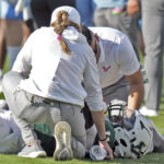 
              Trainers help South Florida quarterback Gerry Bohanon after he was injured against Tulane during the first half of an NCAA college football game Saturday, Oct. 15, 2022, in Tampa, Fla. (AP Photo/Chris O'Meara)
            
