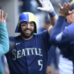
              Seattle Mariners' Curt Casali celebrates in the dugout after his solo home run against the Detroit Tigers during the third inning of the first game of a baseball doubleheader Tuesday, Oct. 4, 2022, in Seattle. (AP Photo/Caean Couto)
            