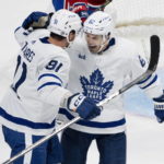 
              Toronto Maple Leafs' Denis Malgin, right, celebrates his goal against the Montreal Canadiens with John Tavares during the second period of an NHL hockey game Wednesday, Oct. 12, 2022, in Montreal. (Paul Chiasson/The Canadian Press via AP)
            