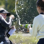 
              Charley Hull, left, of England, is doused after winning the LPGA The Ascendant golf tournament in The Colony, Texas, Sunday, Oct. 2, 2022. (AP Photo/LM Otero)
            