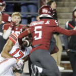 
              Washington State defensive back Derrick Langford Jr. (5) disrupts a pass intended for Utah wide receiver Devaughn Vele (17) during the first half of an NCAA college football game, Thursday, Oct. 27, 2022, in Pullman, Wash. (AP Photo/Young Kwak)
            
