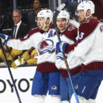 
              Colorado Avalanche center Nathan MacKinnon, left, celebrates his goal with left wing Artturi Lehkonen and right wing Valeri Nichushkin, right, during the first period of the team's NHL hockey game against the Vegas Golden Knights on Saturday, Oct. 22, 2022, in Las Vegas. (AP Photo/Chase Stevens)
            
