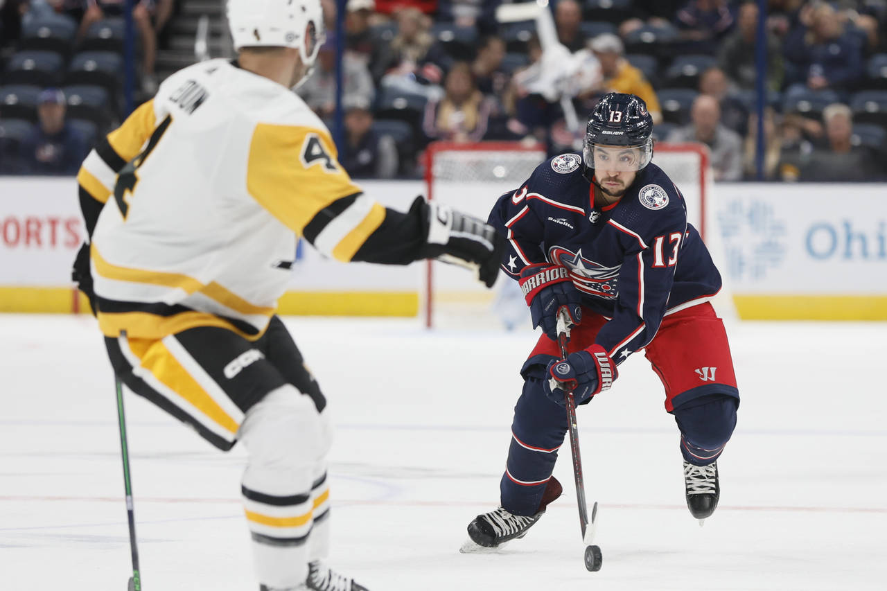 Columbus Blue Jackets' Johnny Gaudreau, right, looks for an open pass against the Pittsburgh Pengui...