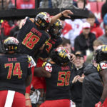 
              Maryland quarterback Taulia Tagovailoa (3) celebrates his touchdown with C.J. Dipre and other teammates in the first half of an NCAA college football game against Purdue, Saturday, Oct. 8, 2022, in College Park, Md. (AP Photo/Gail Burton)
            