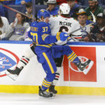 
              Buffalo Sabres center Casey Mittelstadt (37) and Chicago Blackhawks defenseman Jake McCabe (6) collide during the third period of an NHL hockey game, Saturday, Oct. 29, 2022, in Buffalo, N.Y. (AP Photo/Jeffrey T. Barnes)
            