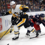 
              Pittsburgh Penguins defenseman Jan Rutta, left, reaches for the puck in front of Columbus Blue Jackets forward Mathieu Olivier during the second period of an NHL hockey game in Columbus, Ohio, Saturday, Oct. 22, 2022. (AP Photo/Paul Vernon)
            