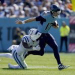 
              Tennessee Titans quarterback Ryan Tannehill (17) runs for a first down before being tackled by Indianapolis Colts linebacker Zaire Franklin (44) during the first half of an NFL football game Sunday, Oct. 23, 2022, in Nashville, Tenn. (AP Photo/Mark Humphrey)
            