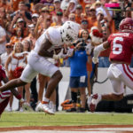 
              Texas tight end Ja'Tavion Sanders (0) runs into the end zone on a touchdown reception in front of Oklahoma defensive backs Trey Morrison (6) and C.J. Coldon (22) during the first half of an NCAA college football game at the Cotton Bowl, Saturday, Oct. 8, 2022, in Dallas. (AP Photo/Jeffrey McWhorter)
            