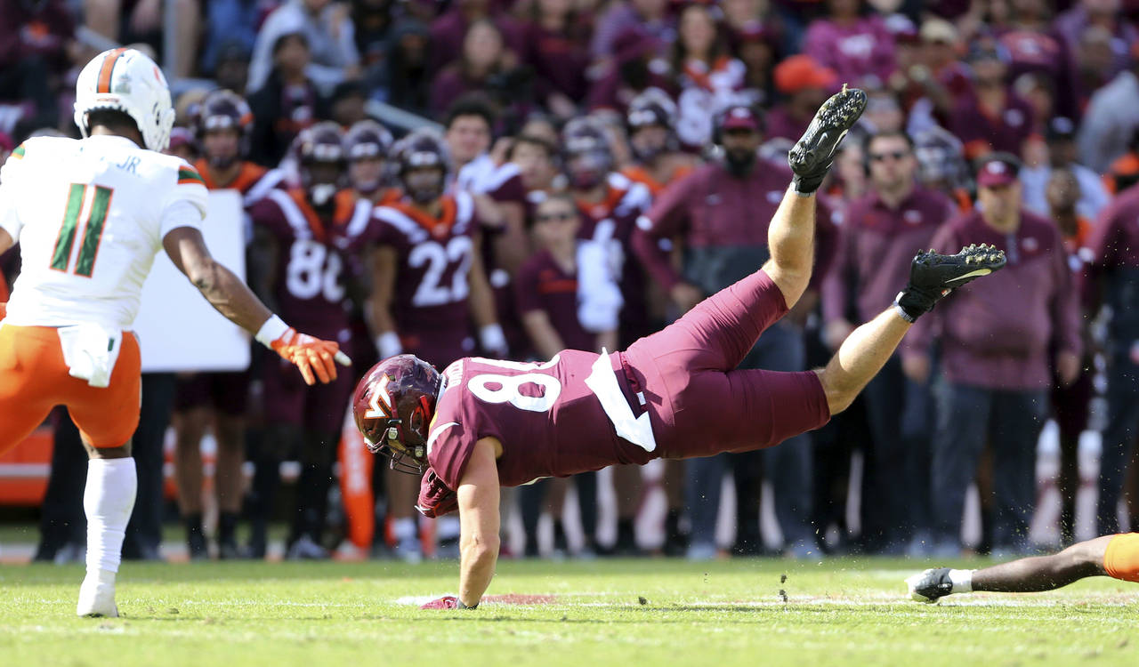 Virginia Tech's Kaleb Smith (80) is upended after catching a pass in the second half of an NCAA foo...