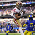 
              San Francisco 49ers running back Christian McCaffrey, center, comes down after making a touchdown catch as Los Angeles Rams cornerback Jalen Ramsey, right, watches during the second half of an NFL football game Sunday, Oct. 30, 2022, in Inglewood, Calif. (AP Photo/Ashley Landis)
            