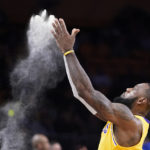 
              Los Angeles Lakers forward LeBron James tosses powder in the air prior to an NBA basketball game against the Los Angeles Clippers Thursday, Oct. 20, 2022, in Los Angeles. (AP Photo/Mark J. Terrill)
            