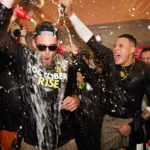 
              The San Diego Padres celebrate in the locker room after defeating the New York Mets in Game 3 of a National League wild-card baseball playoff series to advance to the National League Division Series against the Lost Angeles Dodgers, Sunday, Oct. 9, 2022, in New York. (AP Photo/Frank Franklin II)
            